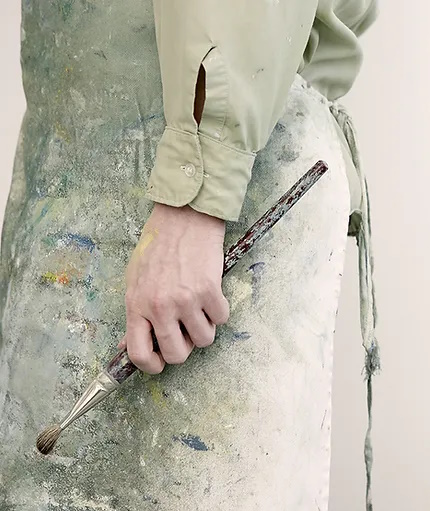 Person holding a paint brush.