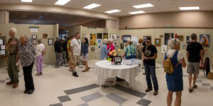 Buckhorn Festival of the Arts Indoor, art on display and a table