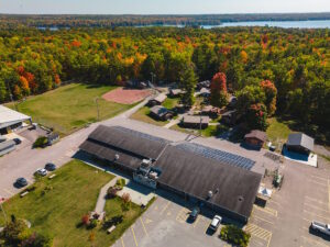 Aerial view of BCC facilities and surrounding forest and lake.